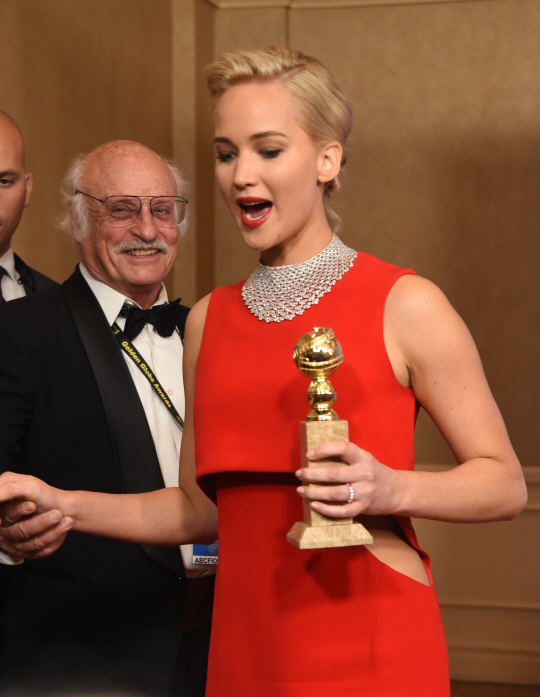 Jennifer Lawrence poses with the award for Best Actress in a Motion Picture, Comedy for her role in "Joy," in the press room at the 73nd annual Golden Globe Awards, January 10, 2016, at the Beverly Hilton Hotel in Beverly Hills, California. AFP PHOTO / FREDERIC J. BROWN