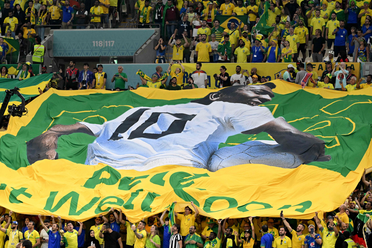 A large flag of Brazil legend Pele is unveiled in the crowd ahead of the Qatar 2022 World Cup Group G football match between Cameroon and Brazil at the Lusail Stadium in Lusail, north of Doha on December 2, 2022. (Photo by Issouf SANOGO / AFP)
