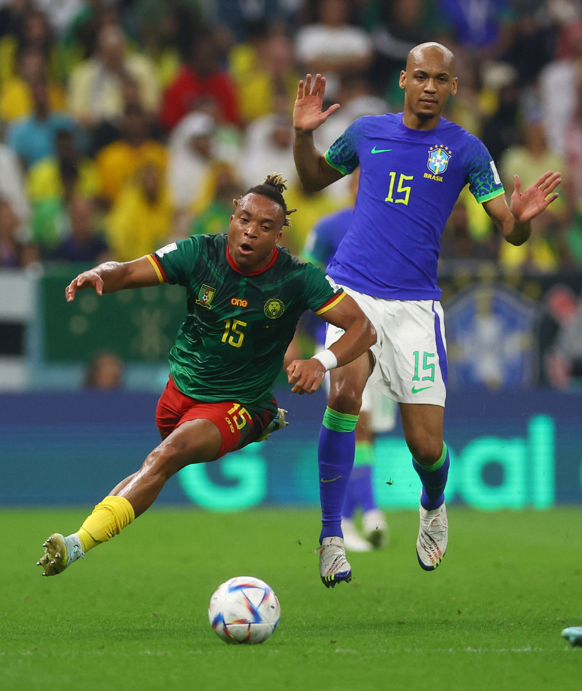 Soccer Football - FIFA World Cup Qatar 2022 - Group G - Cameroon v Brazil - Lusail Stadium, Lusail, Qatar - December 2, 2022 Cameroon's Pierre Kunde in action with Brazil's Fabinho REUTERS/Paul Childs