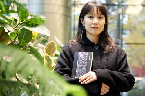 (서울=연합뉴스) 진연수 기자 = 함윤이 작가가 지난 24일 서울 종로구 연합뉴스에서 진행된 인터뷰에 앞서 최근 펴낸 첫 소설집 '자개장의 용도'를 들고 포즈를 취하고 있다. 2025.11.26