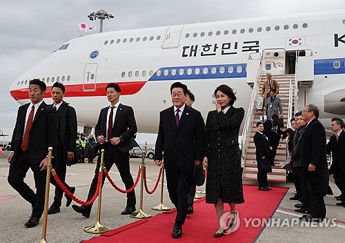 (오사카=연합뉴스) 김도훈 기자 = 이재명 대통령과 김혜경 여사가 13일 일본 오사카 간사이국제공항에 도착한 공군 1호기에서 내려 이동하고 있다. 2026.1.13 superdoo82@yna.co.kr