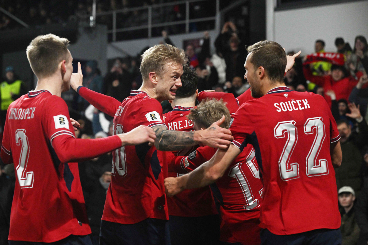 Czech Republic's defender #07 Ladislav Krejci (C) celebrates with team mates after scoring the 2-1 goal during the first period of extra time during the FIFA World Cup 2026 European qualification final football match Czech Republic vs Denmark on March 31, 2026 in Prague, Czech Republic. (Photo by Michal Cizek / AFP)