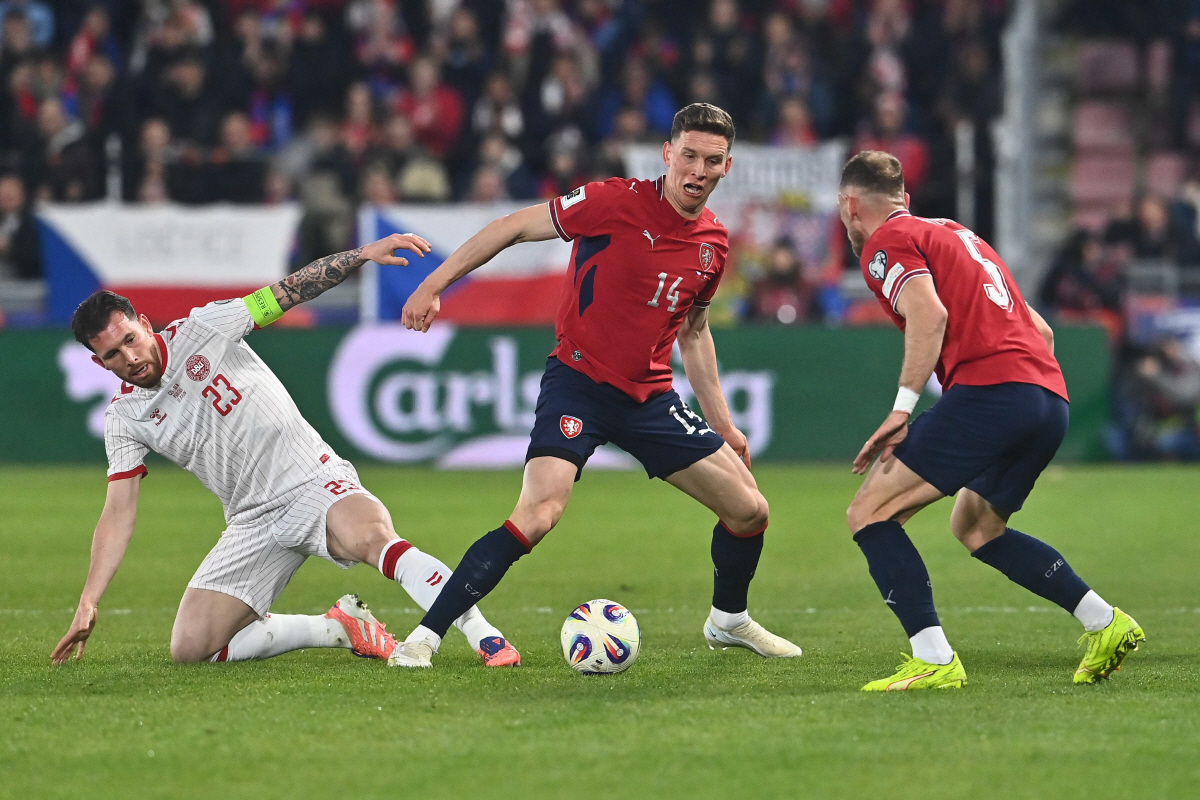 Czech Republic's midfielder #14 Lukas Provod (C) with Denmark's defender #05 Joakim Maehle (R) vie for the ball with Denmark's midfielder #23 Pierre-Emile Hojbjerg (L) during the FIFA World Cup 2026 European qualification final football match Czech Republic vs Denmark on March 31, 2026 in Prague, Czech Republic. (Photo by Michal Cizek / AFP)