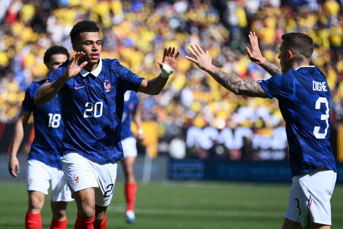 France forward Desire Doue (20) celebrates with Lucas Digne (3) after scoring the opening goal during the international friendly soccer match between Colombia and France in Landover, Md., Sunday, March 29, 2026. (AP Photo/Nick Wass)