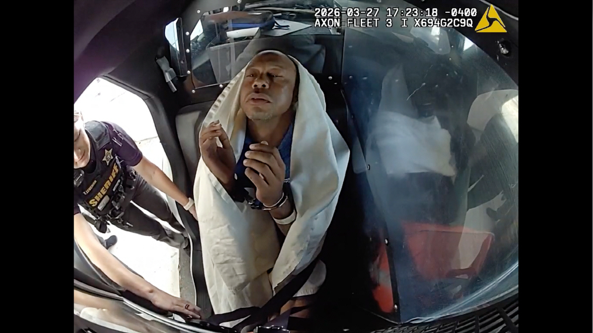 In this image from video provided by the Martin County, Fla., Sheriff's Office, golfer Tiger Woods is strapped into a police vehicle following a car crash in Jupiter Island, Fla., Friday, March 27, 2026. (Martin County Sheriff's Office via AP) AP PROVIDES ACCESS TO THIS PUBLICLY DISTRIBUTED HANDOUT PHOTO PROVIDED BY THE MARTIN COUNTY SHERIFF'S OFFICE; MANDATORY CREDIT. IMAGE TAKEN FROM POLICE BODY CAMERA VIDEO