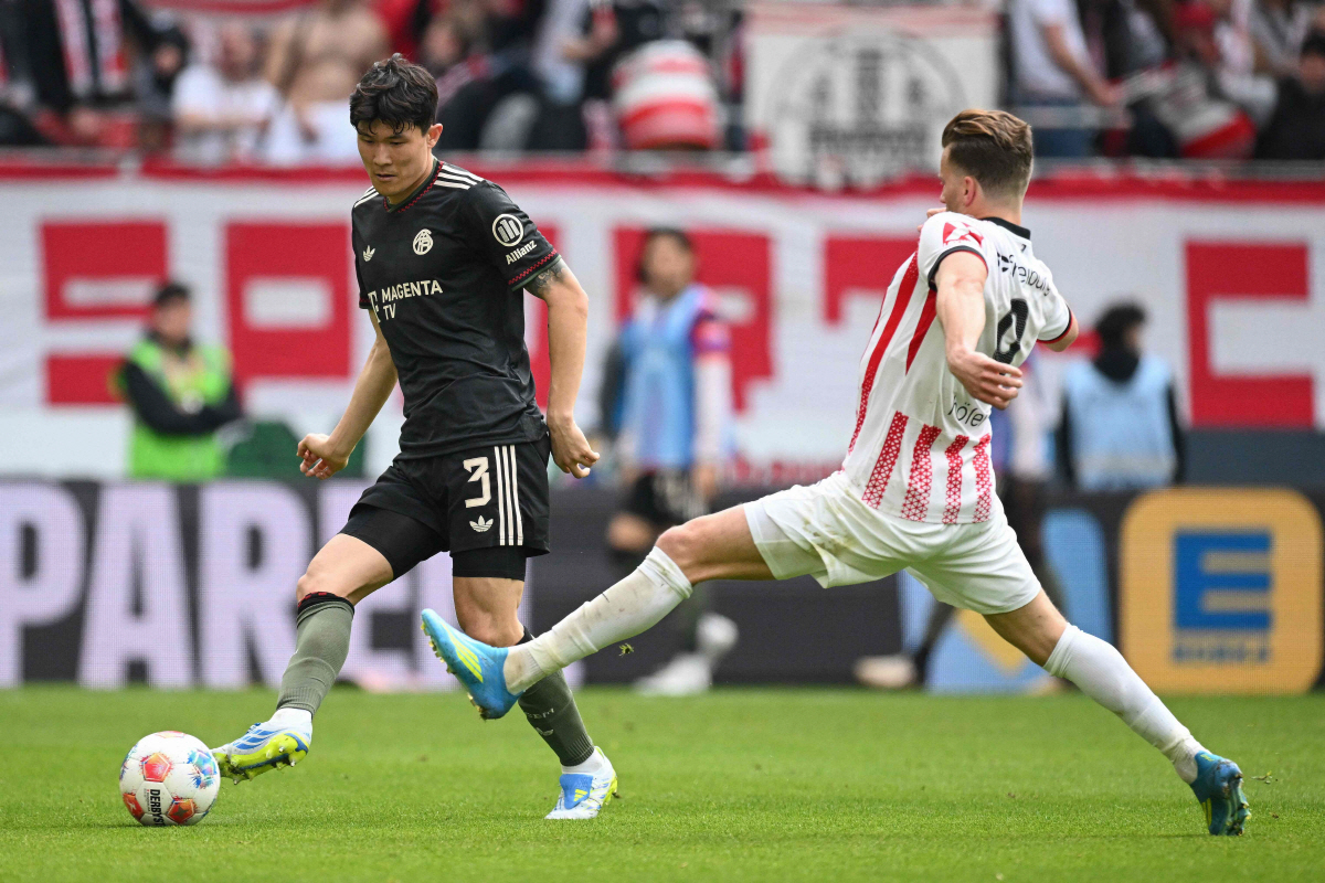 Bayern Munich's South Korean defender #03 Kim Min-Jae and Freiburg's German forward #09 Lucas Hoeler vie for the ball during the German first division Bundesliga football match between SC Freiburg and FC Bayern Munich in Freiburg, southern Germany on April 4, 2026. (Photo by Silas STEIN / AFP) / DFL REGULATIONS PROHIBIT ANY USE OF PHOTOGRAPHS AS IMAGE SEQUENCES AND/OR QUASI-VIDEO