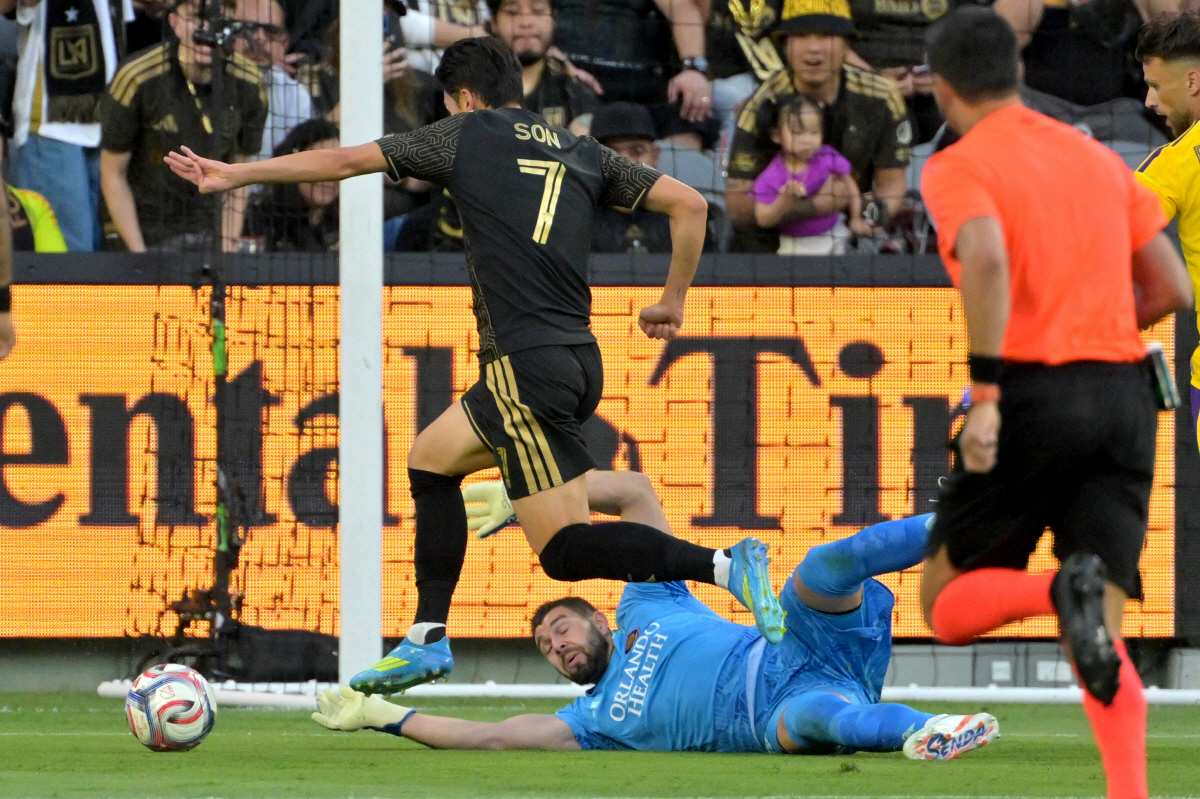 Apr 4, 2026; Los Angeles, California, USA; LAFC forward Son Heung-Min (7) scores past Orlando City goalkeeper Maxime Crepeau (71) in the first half at BMO Stadium. Mandatory Credit: Jayne Kamin-Oncea-Imagn Images