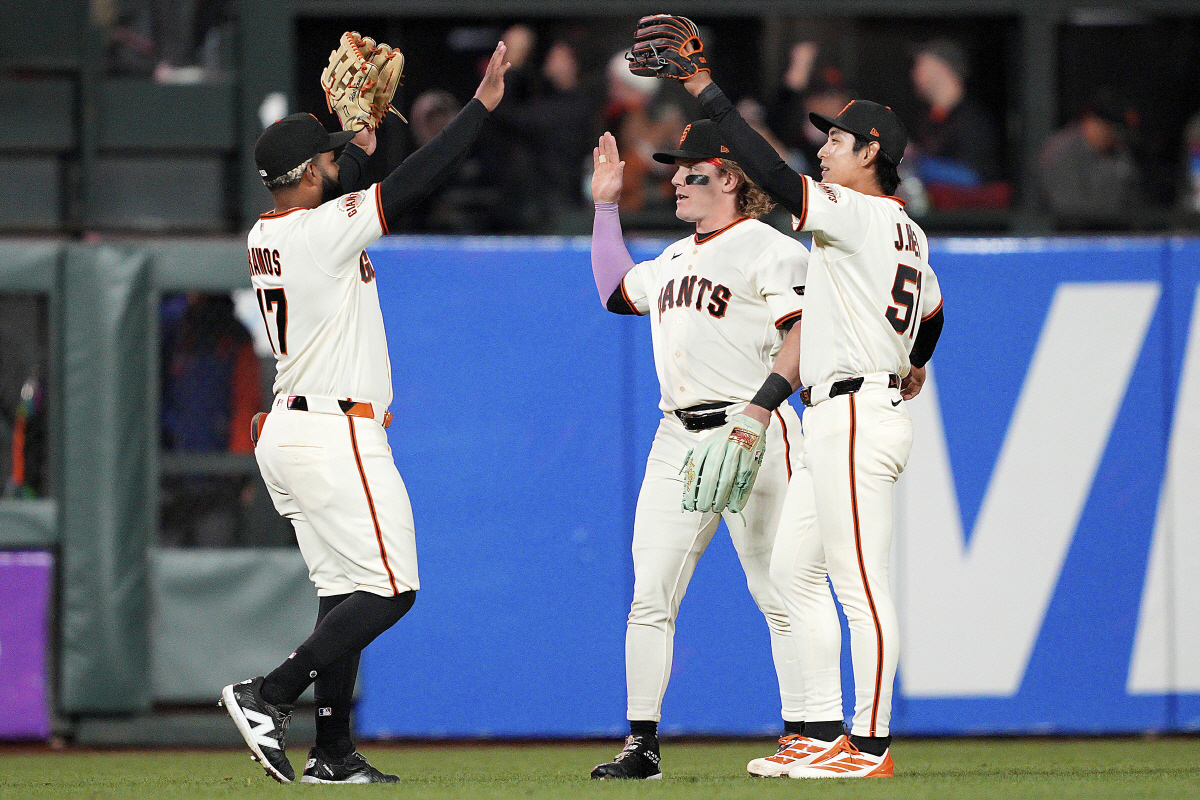 San Francisco Giants' Heliot Ramos, left, Harrison Bader, center, and Jung Hoo Lee celebrate a victory in a baseball game against the New York Mets in San Francisco, Thursday, April 2, 2026. (AP Photo/Tony Avelar)