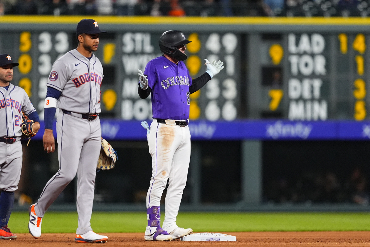 Apr 6, 2026; Denver, Colorado, USA; Colorado Rockies outfielder Troy Johnston (20) reacts after his RBI double next to Houston Astros shortstop Jeremy Pena (3) in the fifth nning at Coors Field. Mandatory Credit: Ron Chenoy-Imagn Images