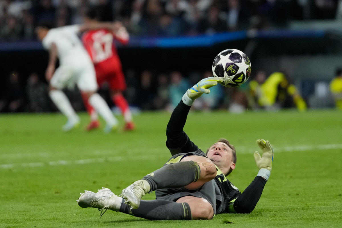 Bayern's goalkeeper Manuel Neuer saves the ball during the Champions League quarterfinal first leg soccer match between Real Madrid and Bayern Munich in Madrid, Spain, Tuesday, April 7, 2026. (AP Photo/Bernat Armangue)