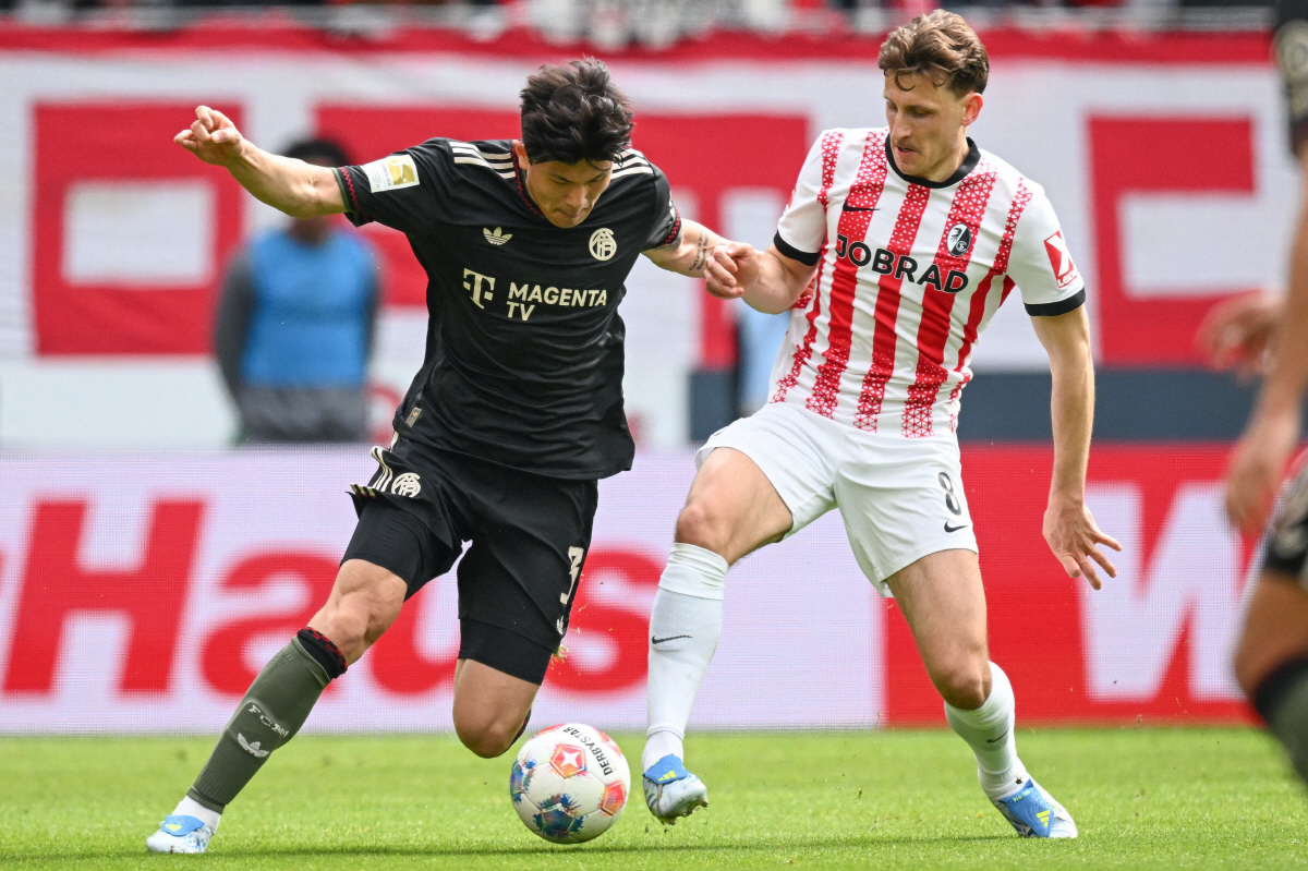 Bayern Munich's South Korean defender #03 Kim Min-Jae (L) and Freiburg's German midfielder #08 Maximilian Eggestein vie for the ball during the German first division Bundesliga football match between SC Freiburg and FC Bayern Munich in Freiburg, southern Germany on April 4, 2026. (Photo by Silas STEIN / AFP) / DFL REGULATIONS PROHIBIT ANY USE OF PHOTOGRAPHS AS IMAGE SEQUENCES AND/OR QUASI-VIDEO