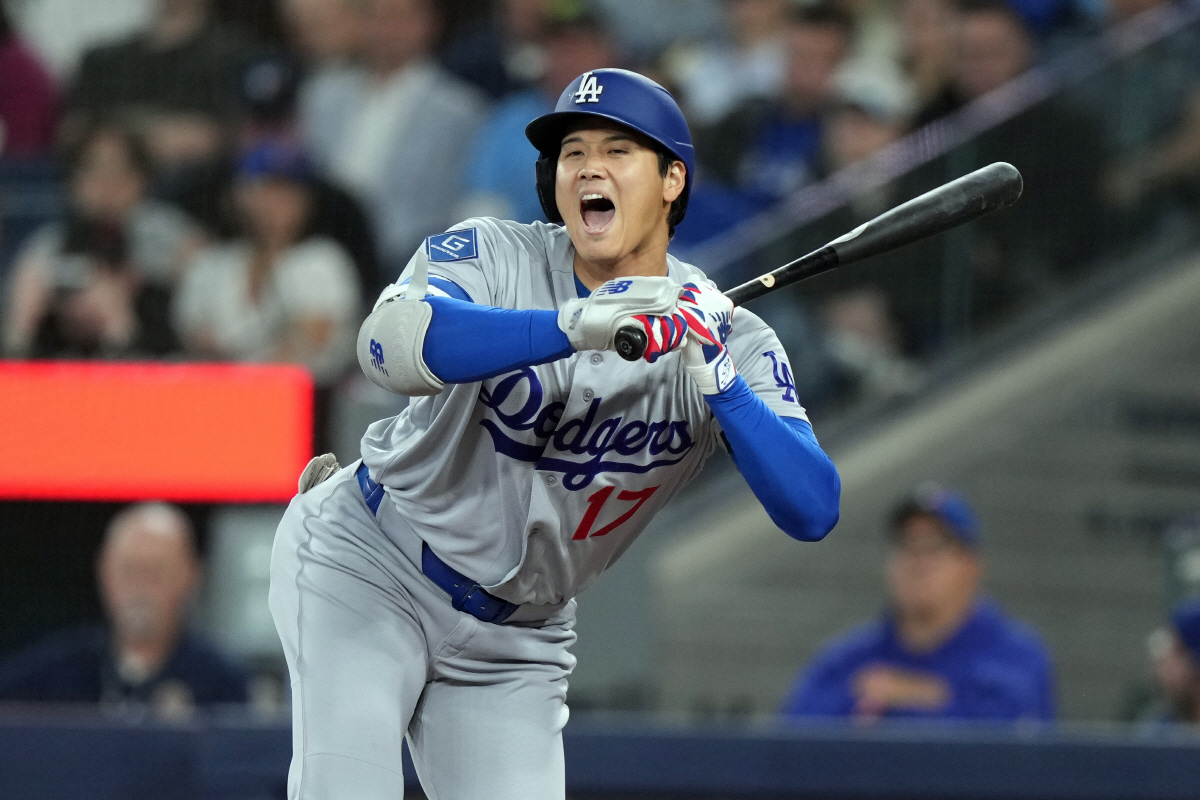Los Angeles Dodgers' Shohei Ohtani (17) reacts to a wild pitch from the Toronto Blue Jays during the first inning of a baseball game in Toronto, Wednesday, April 8, 2026. (Nathan Denette/The Canadian Press via AP) MANDATORY CREDIT