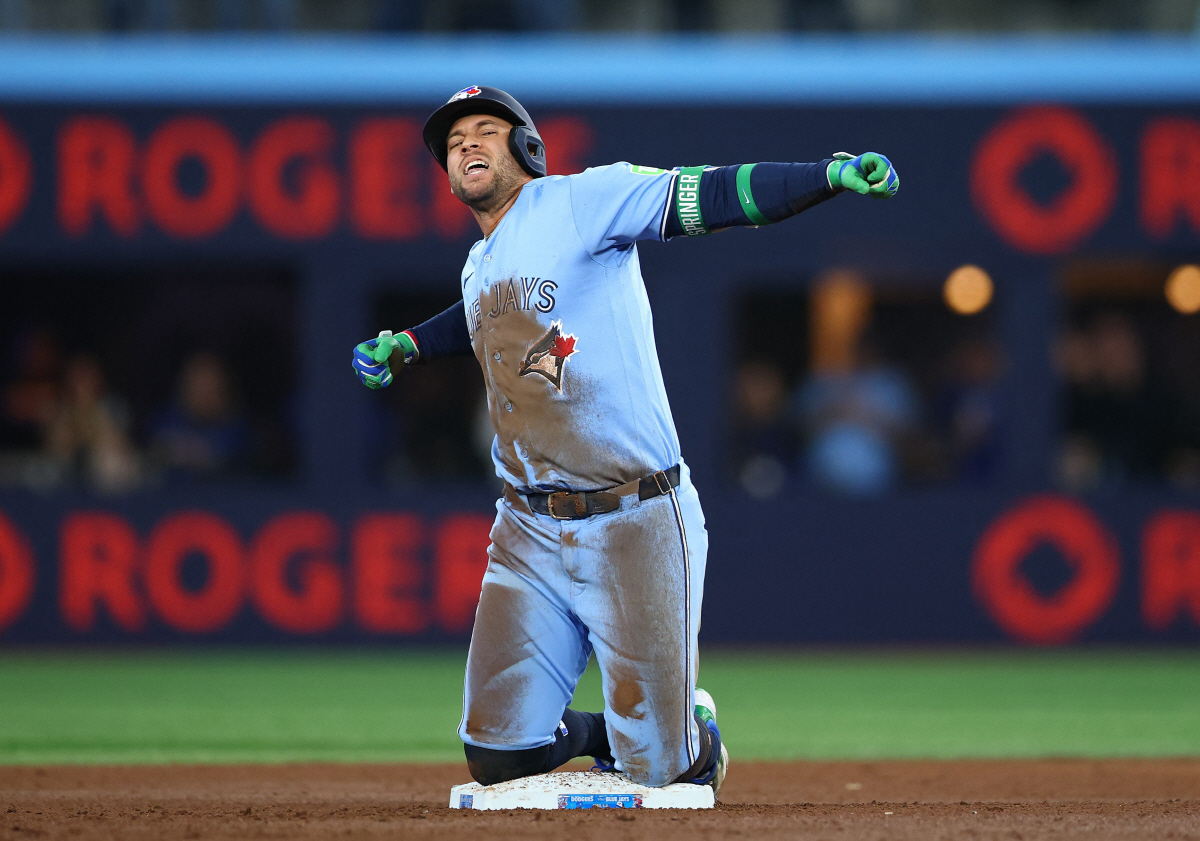 TORONTO, ON - APRIL 08: George Springer #4 of the Toronto Blue Jays reacts after hitting an RBI double in the seventh inning of a game against the Los Angeles Dodgers at Rogers Centre on April 8, 2026 in Toronto, Ontario, Canada. Vaughn Ridley/Getty Images/AFP (Photo by Vaughn Ridley / GETTY IMAGES NORTH AMERICA / Getty Images via AFP)