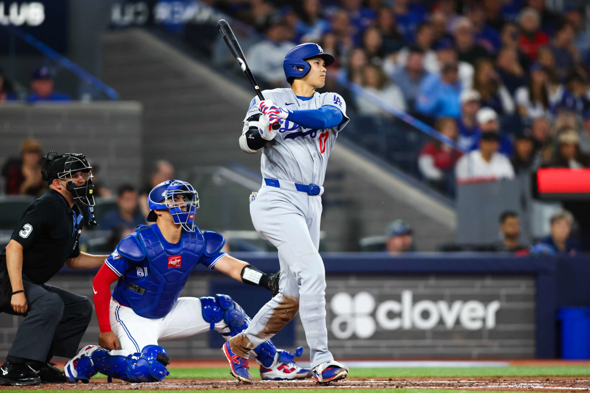 TORONTO, CANADA - APRIL 7: Shohei Ohtani #17 of the Los Angeles Dodgers hits an RBI single to score in Alex Freeland #76 in the third inning of their MLB against the Toronto Blue Jays at Rogers Centre on April 7, 2026 in Toronto, Ontario, Canada. Cole Burston/Getty Images/AFP (Photo by Cole Burston / GETTY IMAGES NORTH AMERICA / Getty Images via AFP)