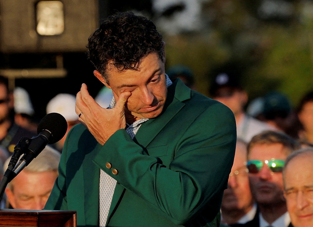 Golf - The Masters - Augusta National Golf Club, Augusta, Georgia, U.S. - April 12, 2026 Northern Ireland's Rory McIlroy celebrates with his green jacket after winning The Masters REUTERS/Mike Blake TPX IMAGES OF THE DAY