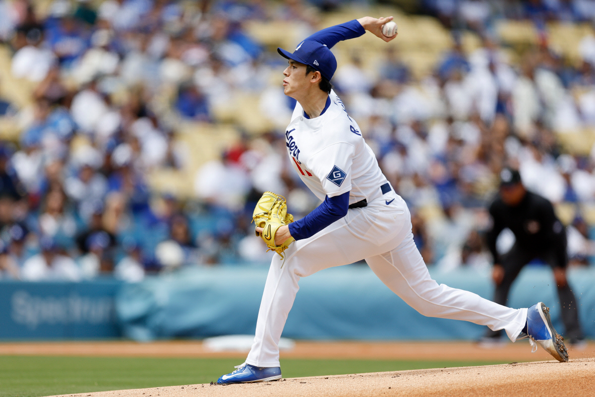 Los Angeles Dodgers starting pitcher Roki Sasaki delivers during the first inning of a baseball game against the Texas Rangers, Sunday, April 12, 2026, in Los Angeles. (AP Photo/Caroline Brehman)