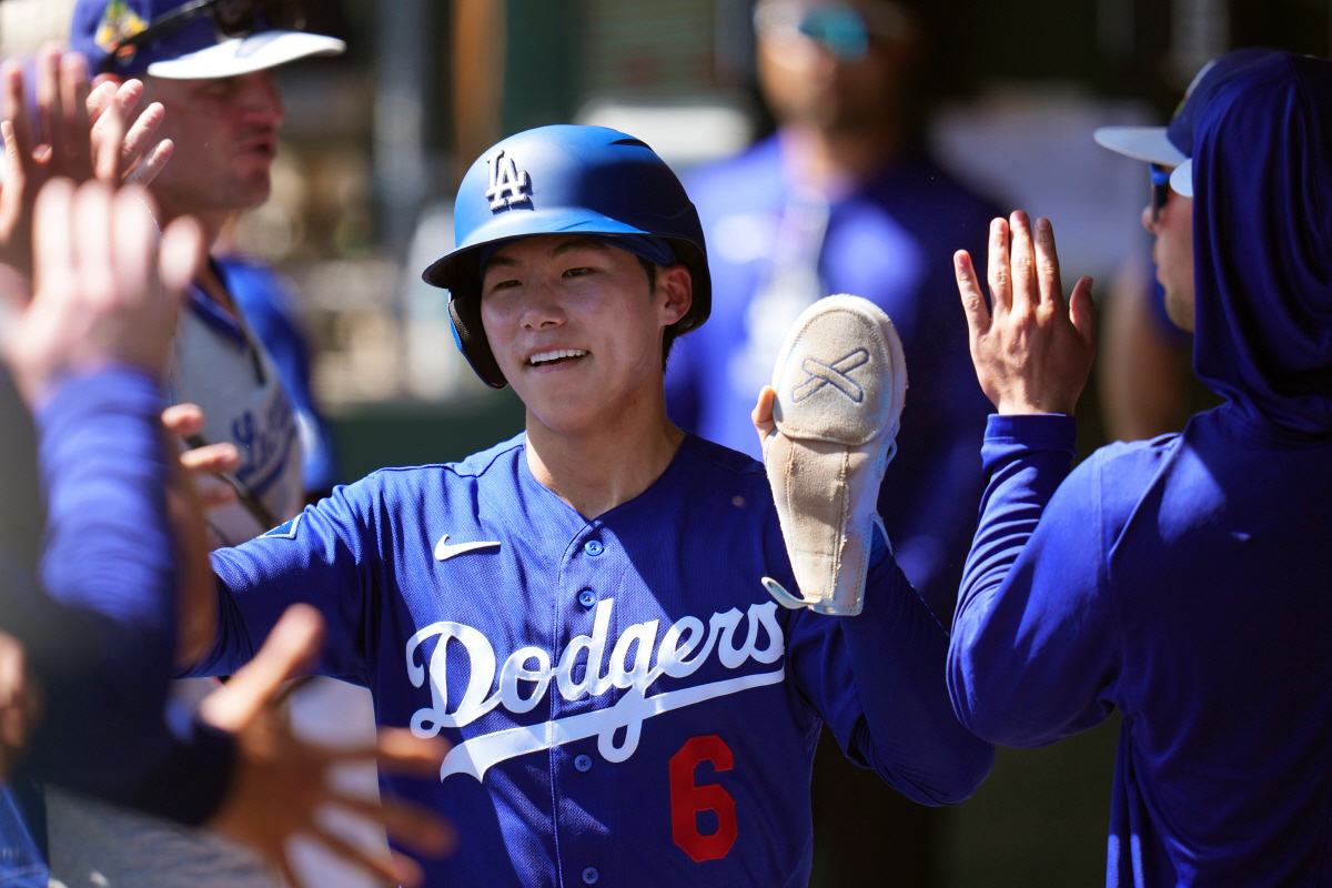 Los Angeles Dodgers' Hyeseong Kim, of South Korea, celebrates his run scored against the Milwaukee Brewers during the second inning of a spring training baseball game, Monday, March 16, 2026, in Phoenix. (AP Photo/Ross D. Franklin)