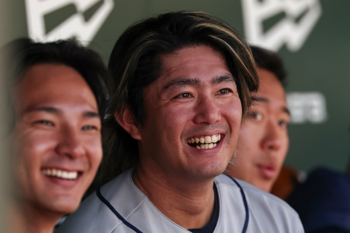 Houston Astros pitcher Tatsuya Imai, center, smiles in the dugout during the third inning of a baseball game against the Athletics, Saturday, April 4, 2026, in West Sacramento, Calif. (AP Photo/Sara Nevis)