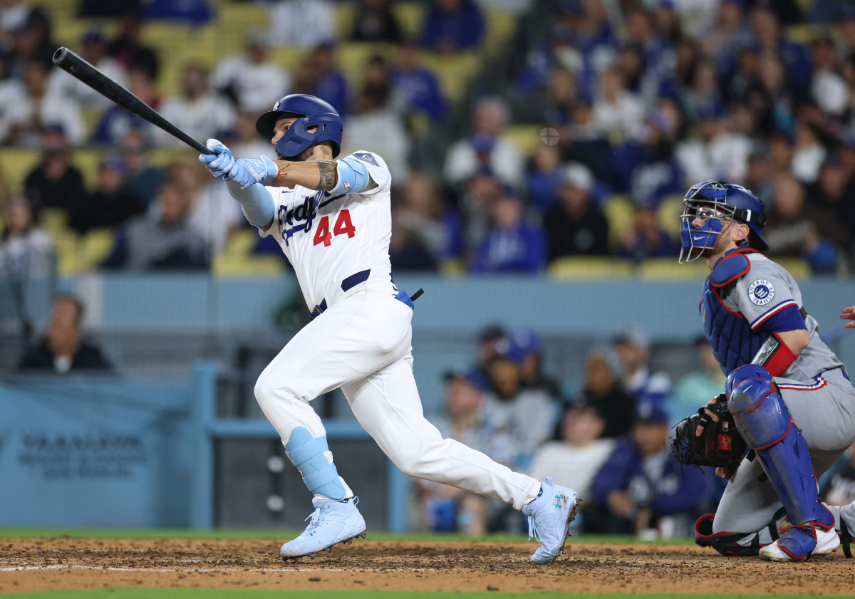 LOS ANGELES, CALIFORNIA - APRIL 10: Andy Pages #44 of the Los Angeles Dodgers hits a two run home run in front of Danny Jansen #9 of the Texas Rangers, to take a 7-4 lead, during the eighth inning at Dodger Stadium on April 10, 2026 in Los Angeles, California. Harry How/Getty Images/AFP (Photo by Harry How / GETTY IMAGES NORTH AMERICA / Getty Images via AFP)