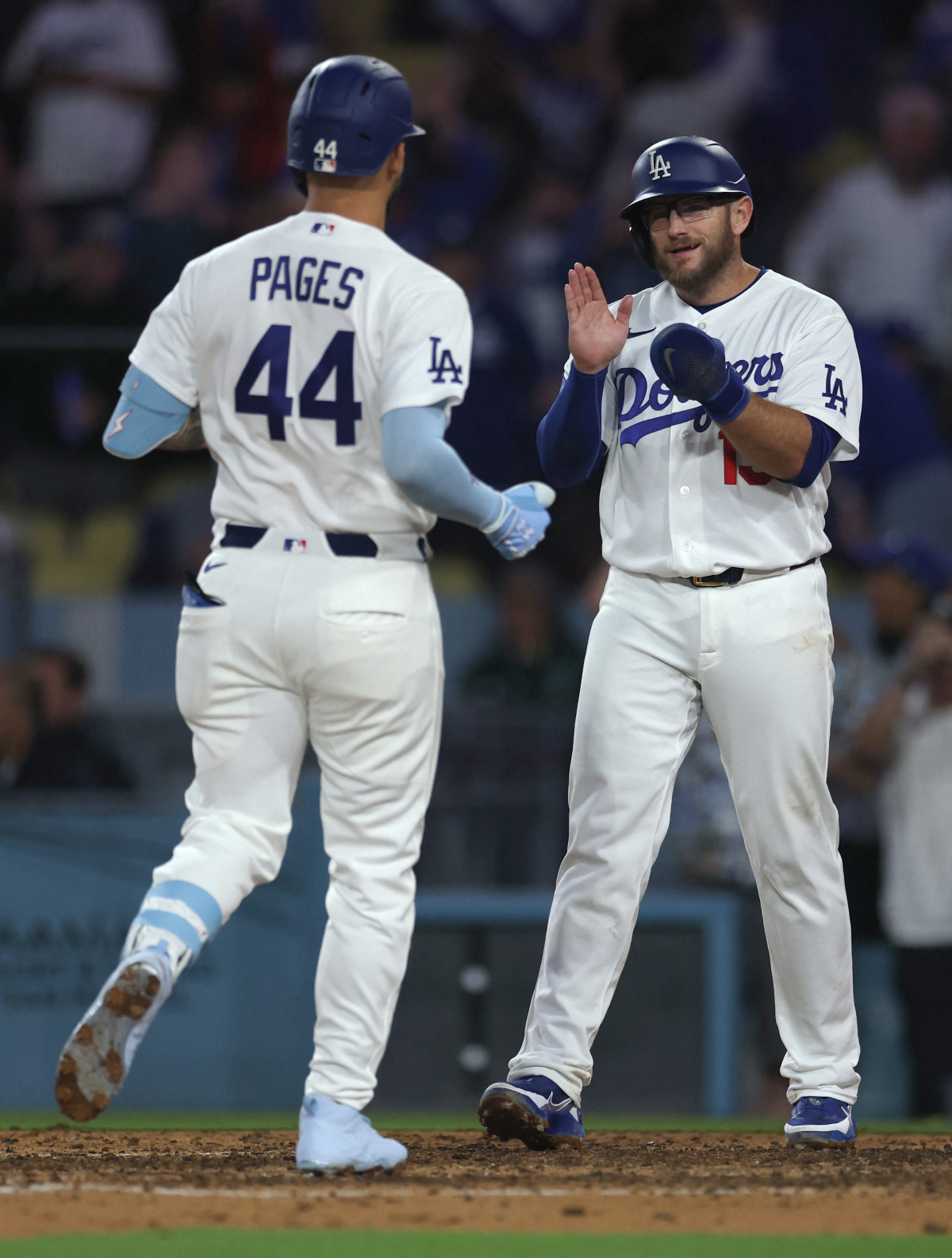 LOS ANGELES, CALIFORNIA - APRIL 10: Andy Pages #44 of the Los Angeles Dodgers celebrates his two run home run with Max Muncy #13, to take a 7-4 lead over the Texas Rangers, during the eighth inning at Dodger Stadium on April 10, 2026 in Los Angeles, California. Harry How/Getty Images/AFP (Photo by Harry How / GETTY IMAGES NORTH AMERICA / Getty Images via AFP)