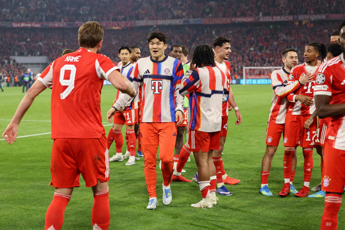 Bayern Munich's players including English forward #09 Harry Kane (L) and Bayern Munich's South Korean defender #03 KimaMin-Jae celebrate after the UEFA Champions League quarter-final second leg football match between FC Bayern Munich and Real Madrid in Munich, southern Germany, on April 15, 2026. (Photo by Alexandra BEIER / AFP)