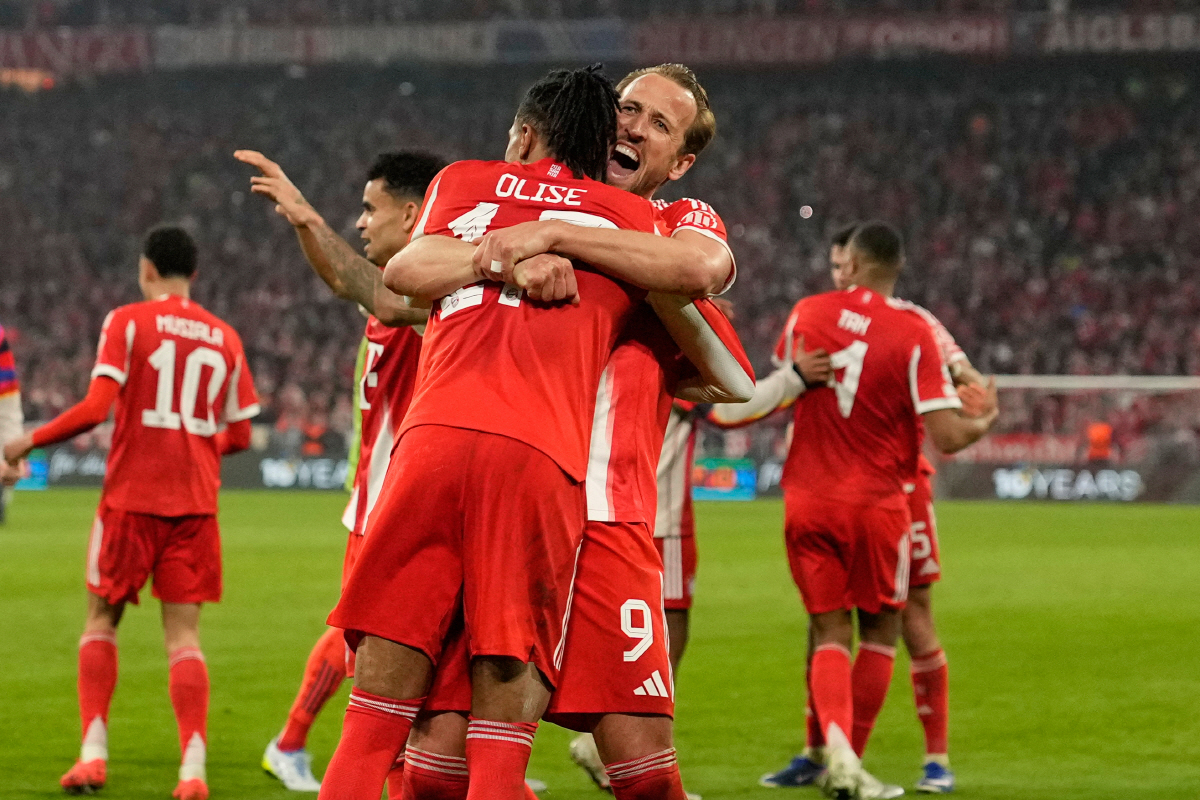 Bayern's Michael Olise celebrates with Harry Kane after scoring his side's fourth goal uring the Champions League quarterfinal second leg soccer match between Bayern Munich and Real Madrid in Munich, Germany, Wednesday, April 15, 2026. (AP Photo/Matthias Schrader)