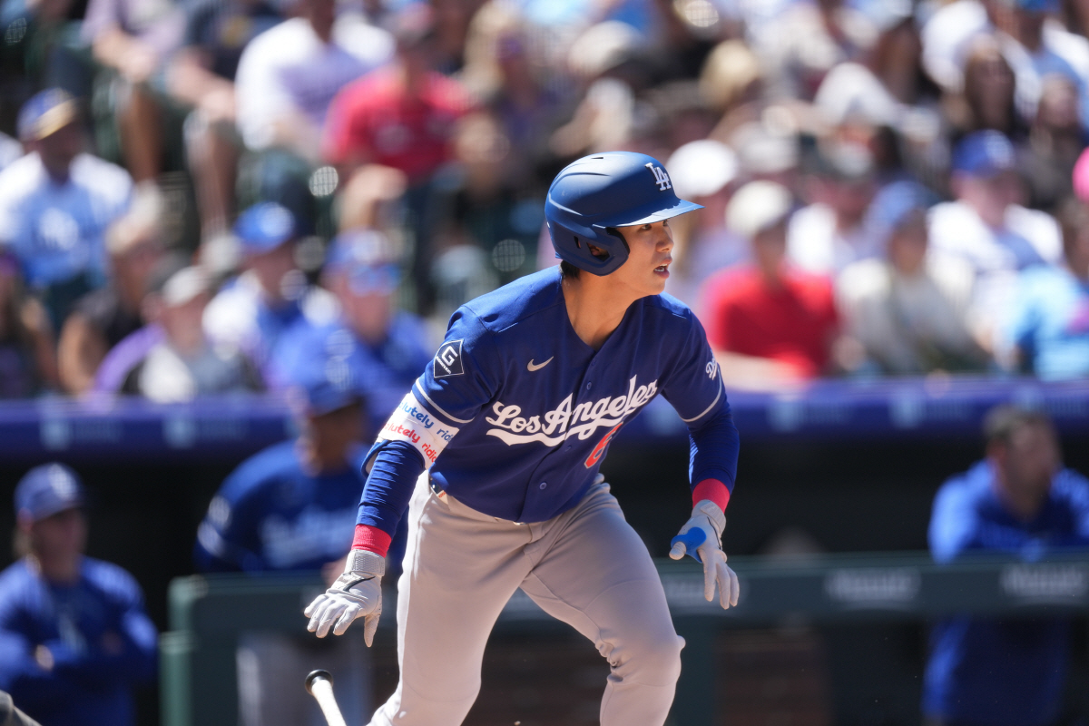 Los Angeles Dodgers' Hyeseong Kim heads up the first base line after connecting for a double off Colorado Rockies starting pitcher Michael Lorenzen in the third inning of a baseball game Sunday, April 19, 2026, in Denver. (AP Photo/David Zalubowski)