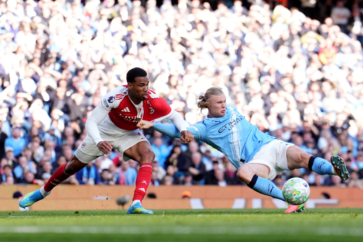 Manchester City's Erling Haaland scores his side's second goal during the English Premier League soccer match between Manchester City and and Arsenal, in Manchester, England, Sunday, April 19, 2026. (Martin Rickett/PA via AP) UNITED KINGDOM OUT; NO SALES; NO ARCHIVE; PHOTOGRAPH MAY NOT BE STORED OR USED FOR MORE THAN 14 DAYS AFTER THE DAY OF TRANSMISSION; MANDATORY CREDIT