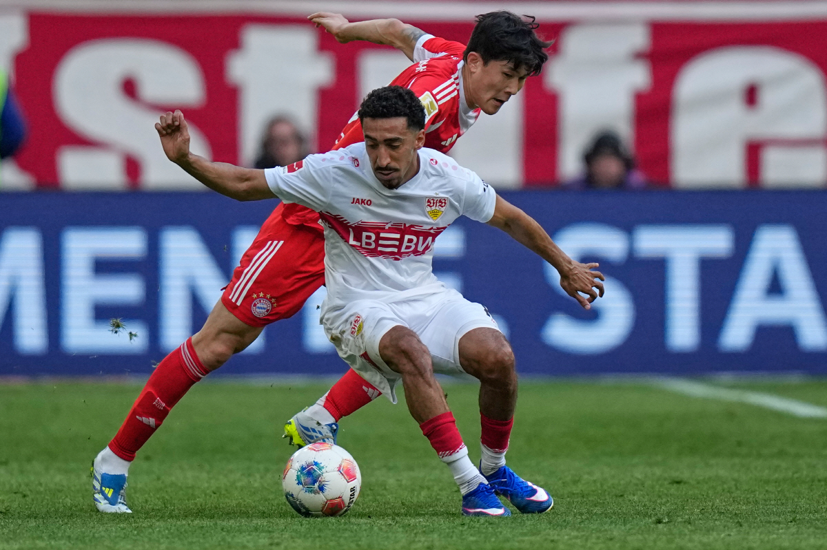 Stuttgart's Tiago Tomas, left, and Bayern's Kim Min-jae fight for the ball during a Bundesliga soccer match between Bayern and Stuttgart in Munich, Germany, Sunday, April 19, 2026. (AP Photo/Matthias Schrader) THE DEUTSCHE FUSSBALL LIGA DFL DOES NOT ALLOW ITS IMAGES TO BE USED AS SEQUENCES TO EMULATE VIDEO