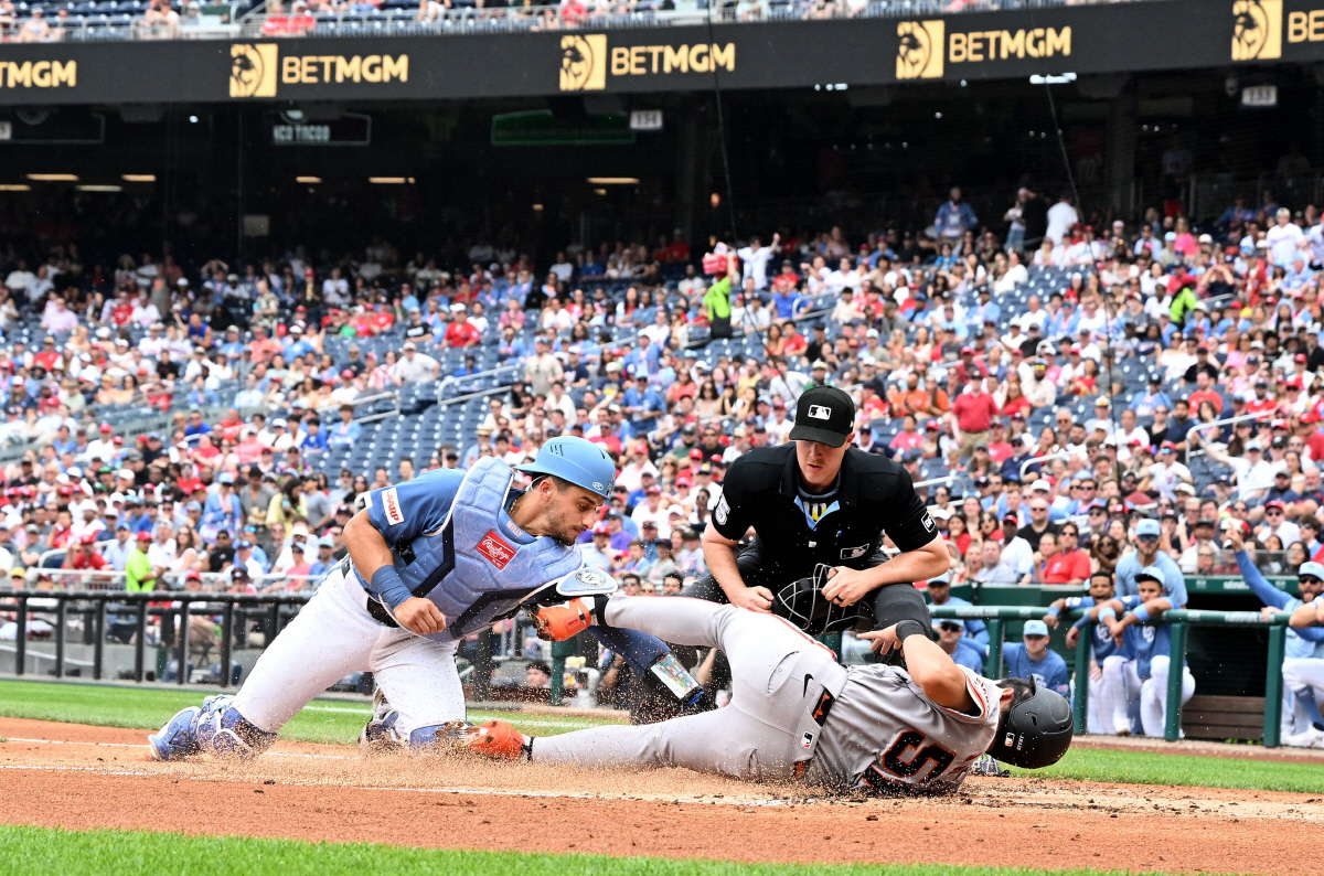 WASHINGTON, DC - APRIL 18: Jung Hoo Lee #51 of the San Francisco Giants is tagged out at home plate in the second inning by Drew Millas #14 of the Washington Nationals at Nationals Park on April 18, 2026 in Washington, DC. Greg Fiume/Getty Images/AFP (Photo by Greg Fiume / GETTY IMAGES NORTH AMERICA / Getty Images via AFP)