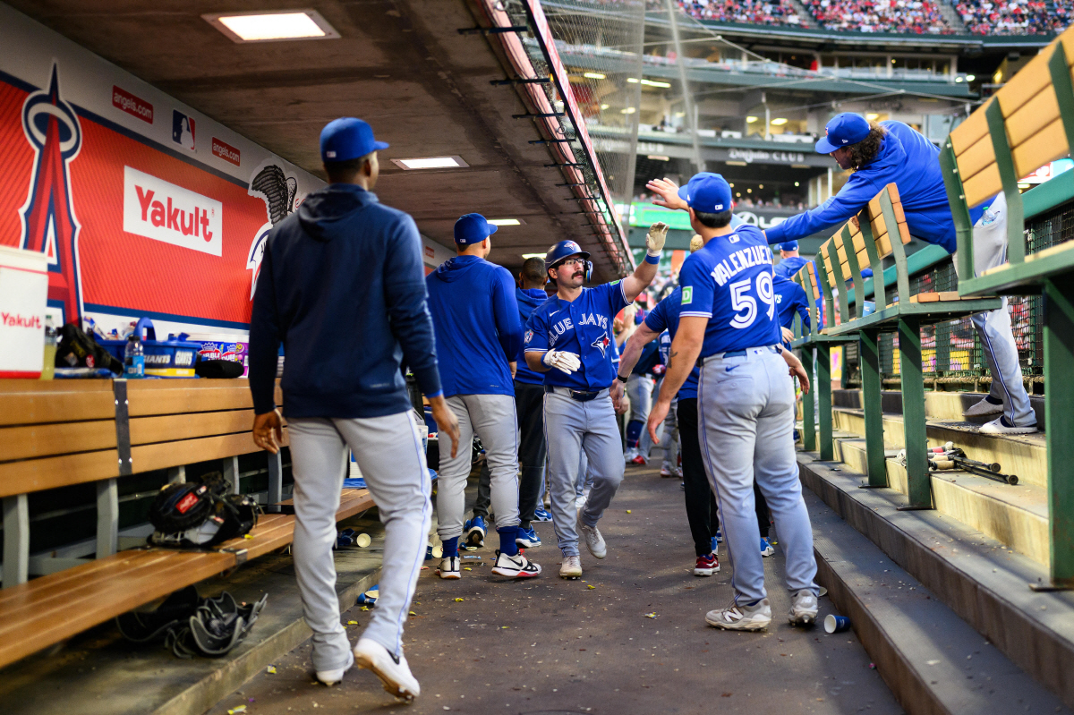 Apr 20, 2026; Anaheim, California, USA; Toronto Blue Jays left fielder Davis Schneider (36) is greeted by teammates after scoring during the third inning against the Los Angeles Angels at Angel Stadium. Mandatory Credit: William Liang-Imagn Images
