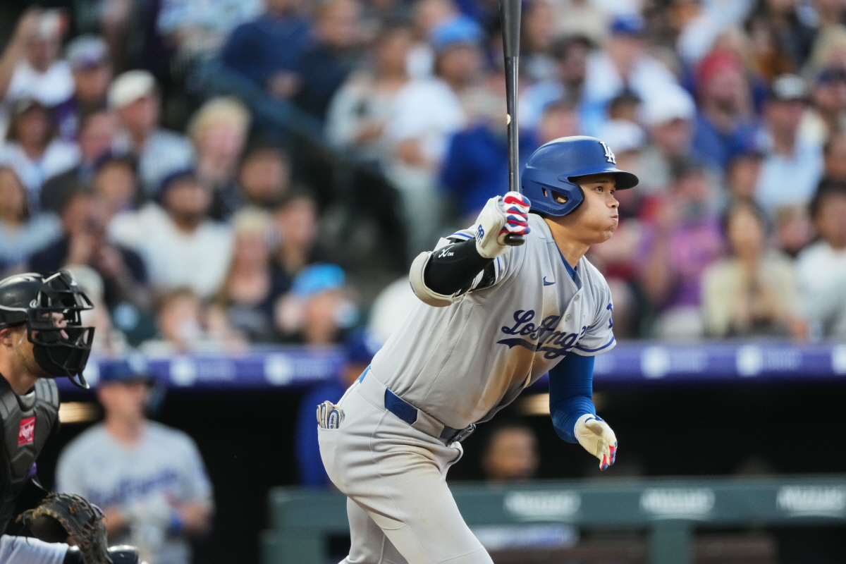Los Angeles Dodgers' Shohei Ohtani breaks from the batter's box after connecting for a single off Colorado Rockies starting pitcher Jose Quintana in the third inning of a baseball game Monday, April 20, 2026, in Denver. (AP Photo/David Zalubowski)