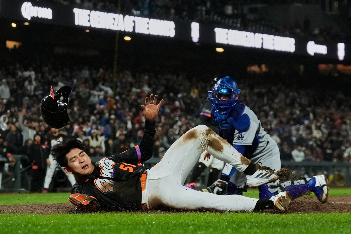 San Francisco Giants' Jung Hoo Lee (51) is tagged out at home by Los Angeles Dodgers catcher Dalton Rushing (68) during the sixth inning of a baseball game Tuesday, April 21, 2026, in San Francisco. (AP Photo/Godofredo A. Vasquez)
