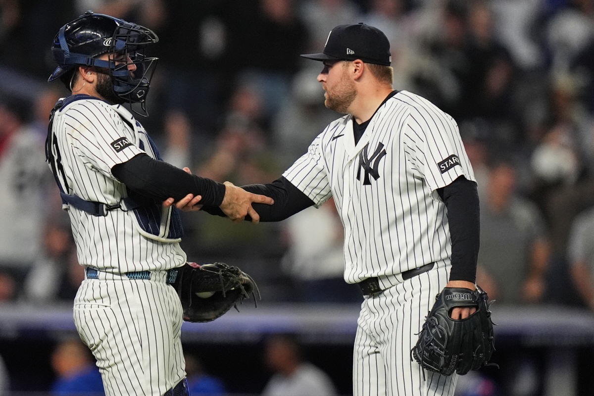 New York Yankees pitcher David Bednar, right, celebrates with catcher Austin Wells after a baseball game against the Kansas City Royals Friday, April 17, 2026, in New York. (AP Photo/Frank Franklin II)
