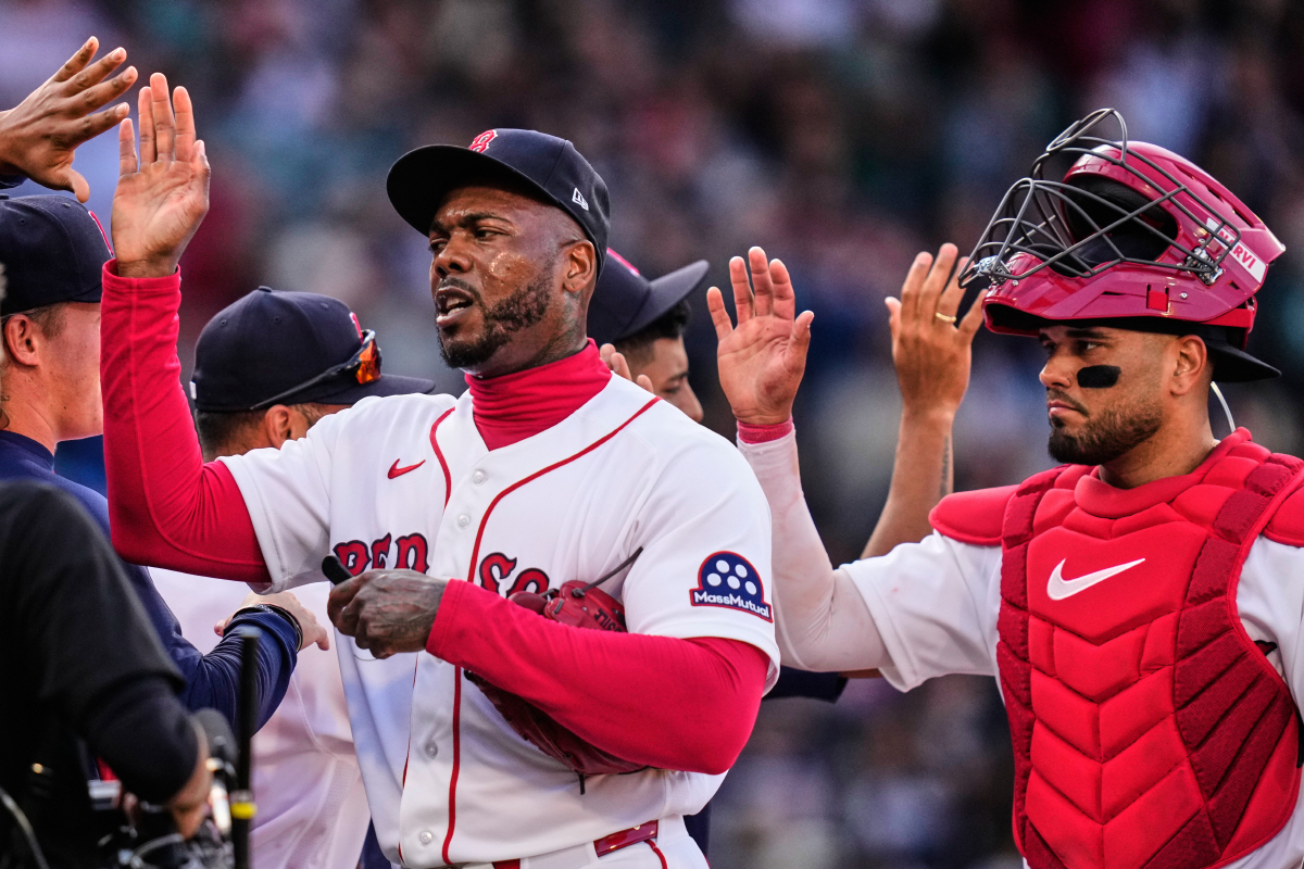 Boston Red Sox pitcher Aroldis Chapman, left, and catcher Carlos Narvaez, right, celebrate after a win over the San Diego Padres in a home-opener baseball game at Fenway Park, Friday, April 3, 2026, in Boston. (AP Photo/Charles Krupa)