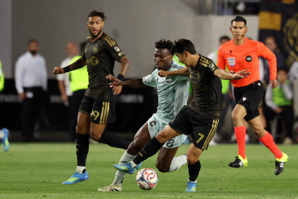 Apr 22, 2026; Los Angeles, California, USA; LAFC forward Son Heung-Min (7) fight for the ball against Colorado Rapids midfielder Hamzat Ojediran (8) during the first half at BMO Stadium. Mandatory Credit: Kiyoshi Mio-Imagn Images