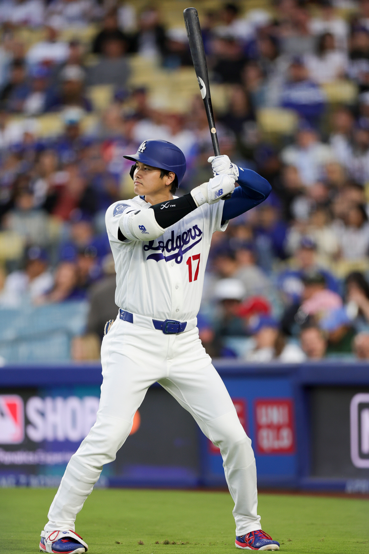 Los Angeles Dodgers designated hitter Shohei Ohtani stands in the on-deck circle before his at-bat during the first inning of a baseball game against the Chicago, Cubs Friday, April 24, 2026, in Los Angeles. (AP Photo/Ryan Sun)