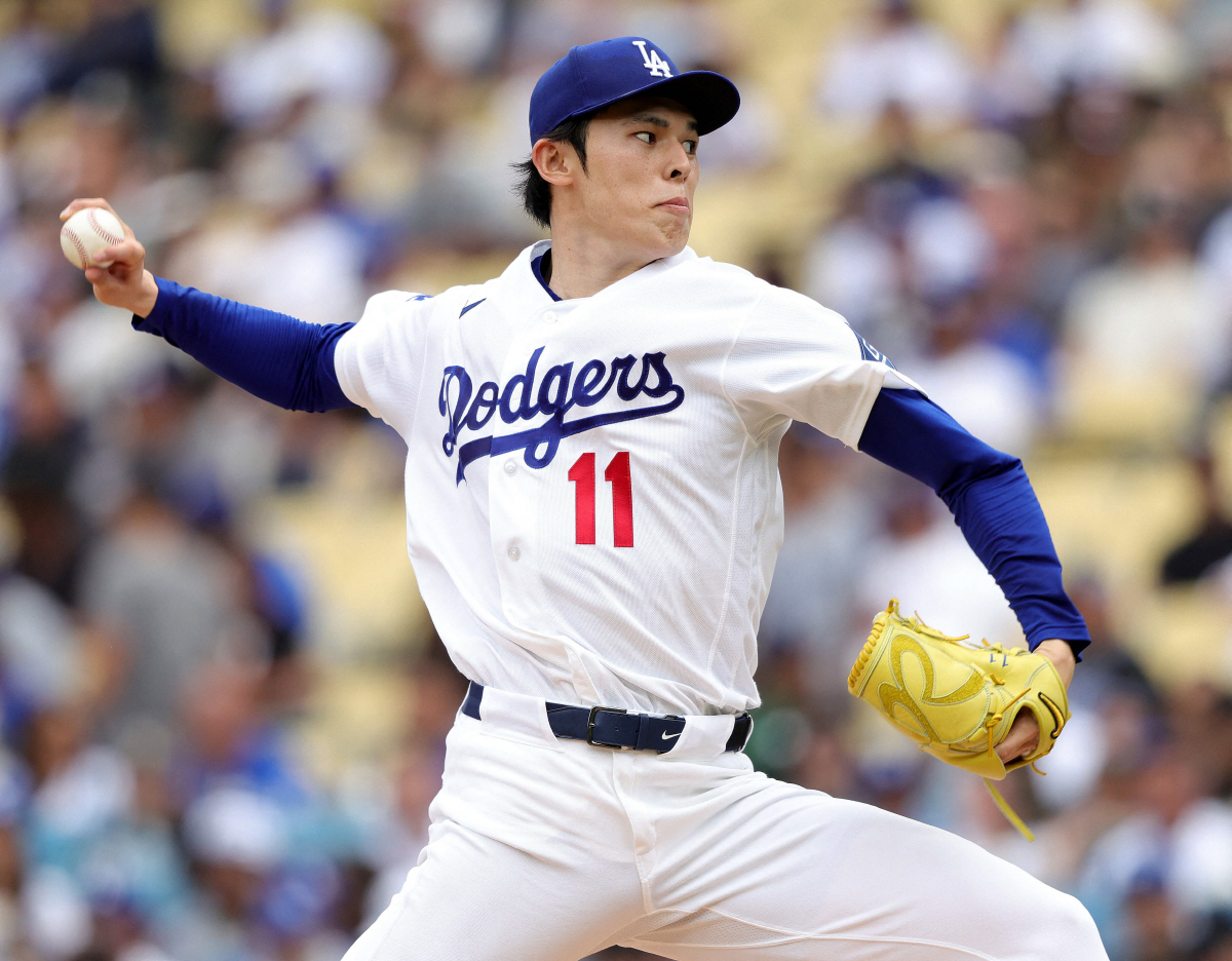 LOS ANGELES, CALIFORNIA - APRIL 12: Roki Sasaki #11 of the Los Angeles Dodgers throws against the Texas Rangers in the fourth inning at Dodger Stadium on April 12, 2026 in Los Angeles, California. Ronald Martinez/Getty Images/AFP (Photo by RONALD MARTINEZ / GETTY IMAGES NORTH AMERICA / Getty Images via AFP)