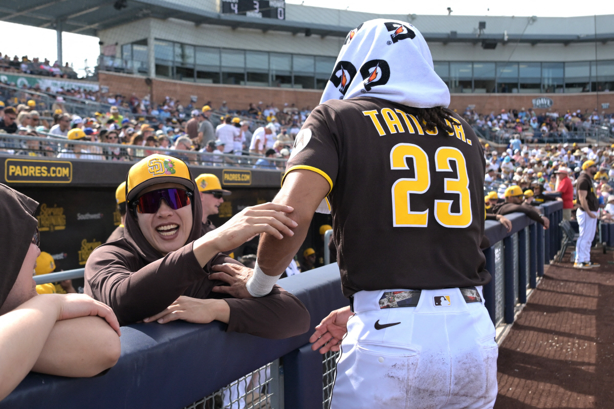 Feb 23, 2026; Peoria, Arizona, USA; San Diego Padres third baseman Sung-Mun Song (24) and San Diego Padres right fielder Fernando Tatis Jr. (23) share a laugh in the dugout during the game against the Milwaukee Brewers at Peoria Sports Complex. Mandatory Credit: Jayne Kamin-Oncea-Imagn Images