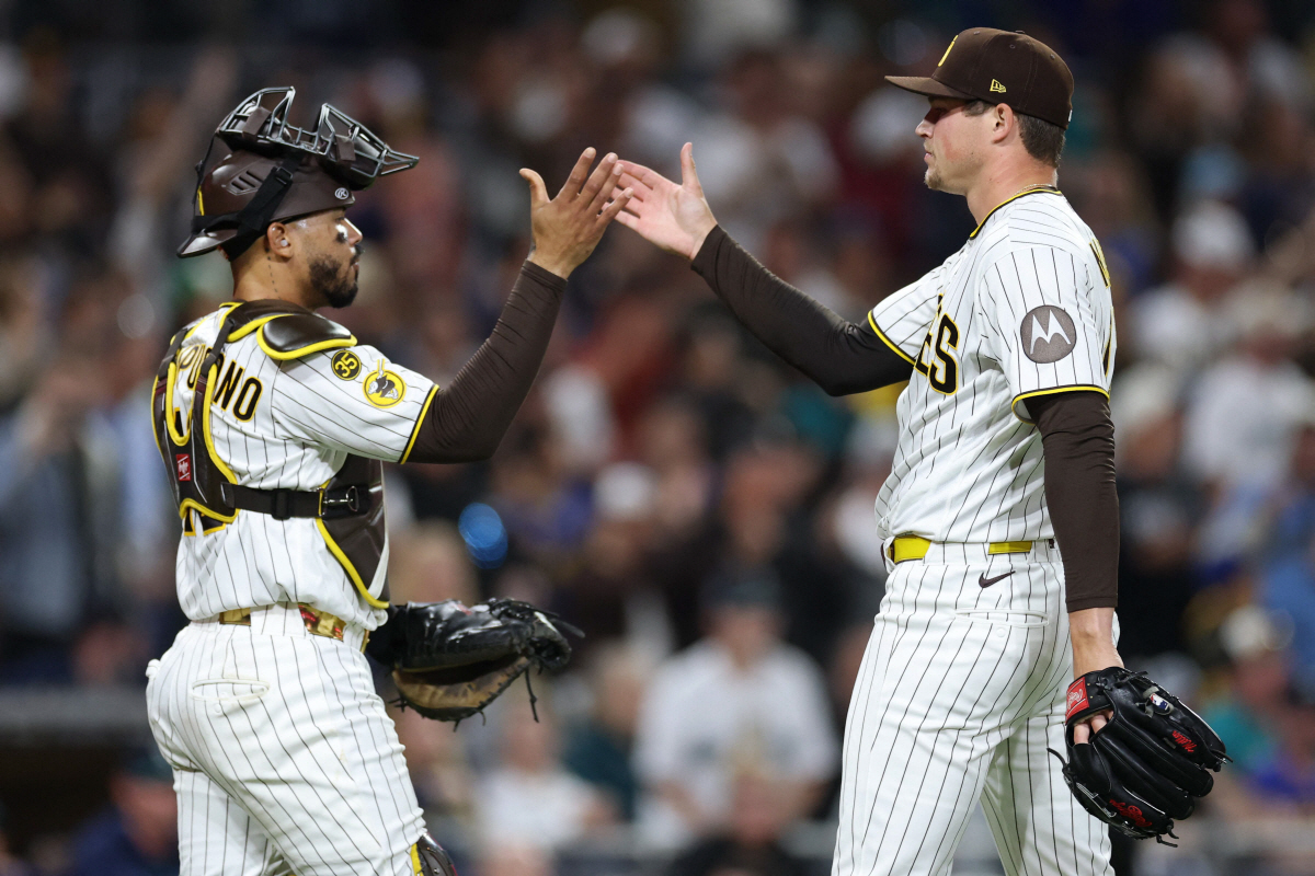 SAN DIEGO, CALIFORNIA - APRIL 16: Luis Campusano #12 celebrates with Mason Miller #22 of the San Diego Padres after defeating the Seattle Mariners 5-2 at Petco Park on April 16, 2026 in San Diego, California. Sean M. Haffey/Getty Images/AFP (Photo by Sean M. Haffey / GETTY IMAGES NORTH AMERICA / Getty Images via AFP)