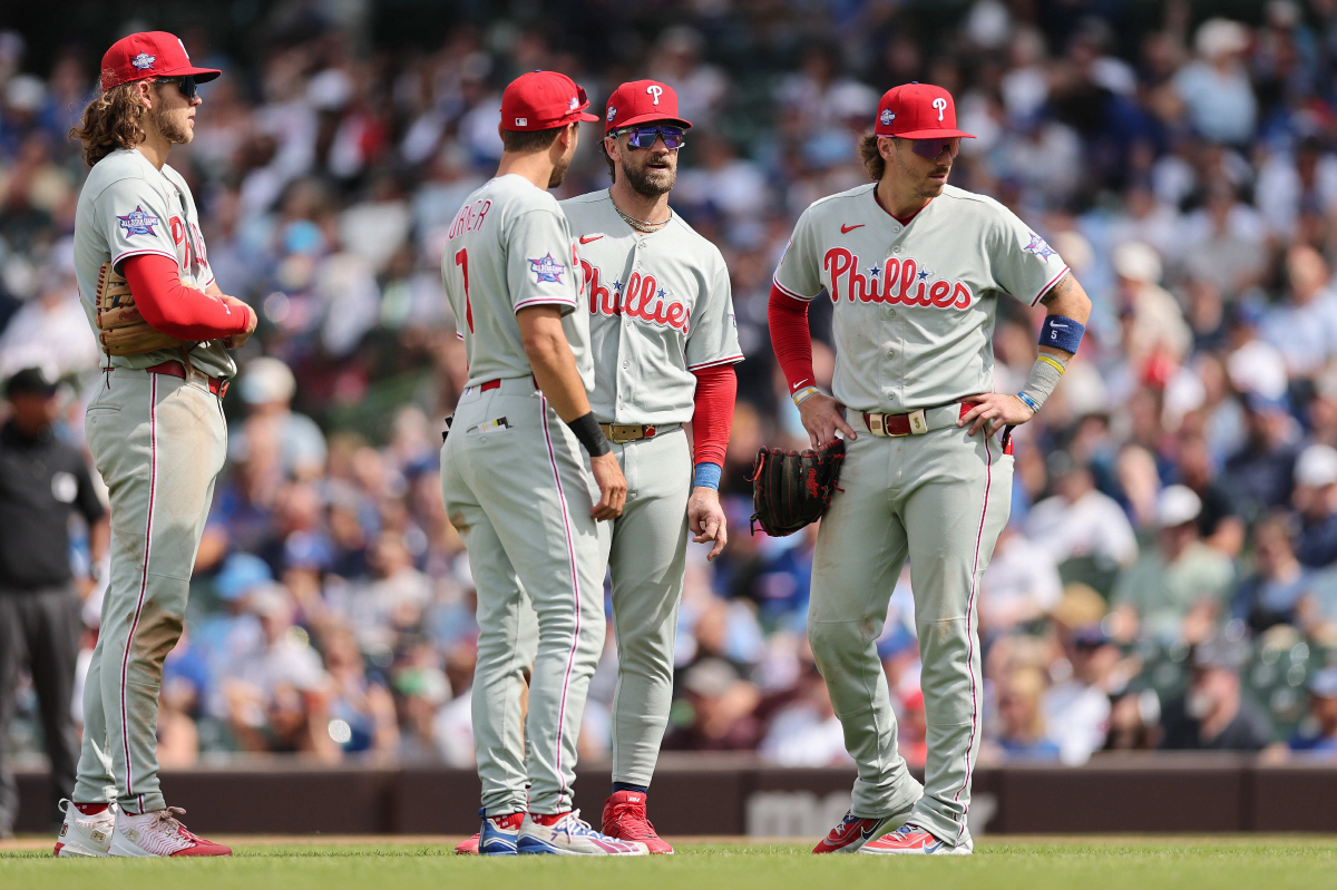 CHICAGO, ILLINOIS - APRIL 23: Alec Bohm #28, Trea Turner #7, Bryce Harper #3 and Bryson Stott #5 of the Philadelphia Phillies look on against the Chicago Cubs at Wrigley Field on April 23, 2026 in Chicago, Illinois. Michael Reaves/Getty Images/AFP (Photo by Michael Reaves / GETTY IMAGES NORTH AMERICA / Getty Images via AFP)
