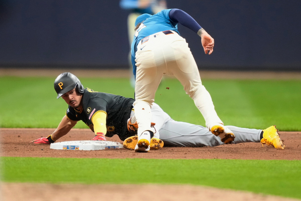 Pittsburgh Pirates' Konnor Griffin, left, steals second against Milwaukee Brewers second baseman Brice Turang, right, during the fifth inning of a baseball game, Friday, April 24, 2026, in Milwaukee. (AP Photo/Kayla Wolf)