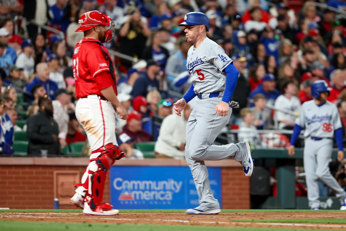 Los Angeles Dodgers' Freddie Freeman scores a run on a sacrifice fly by Kyle Tucker during the sixth inning of a baseball game against the St. Louis Cardinals Friday, May 1, 2026, in St. Louis. (AP Photo/Scott Kane)