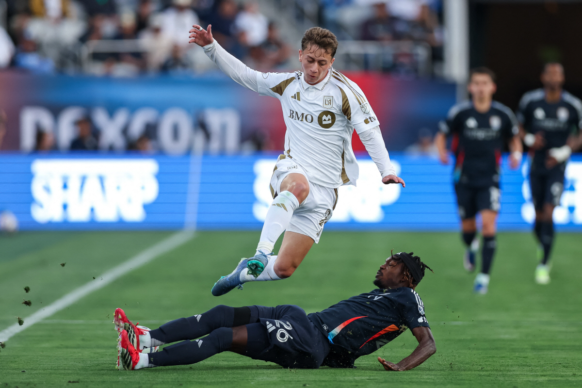 May 2, 2026; San Diego, California, USA; San Diego FC defender Manu Duah (26) tackles the ball away from Los Angeles Football Club forward Nathan Ordaz (27) during the first half at Snapdragon Stadium. Mandatory Credit: Chadd Cady-Imagn Images