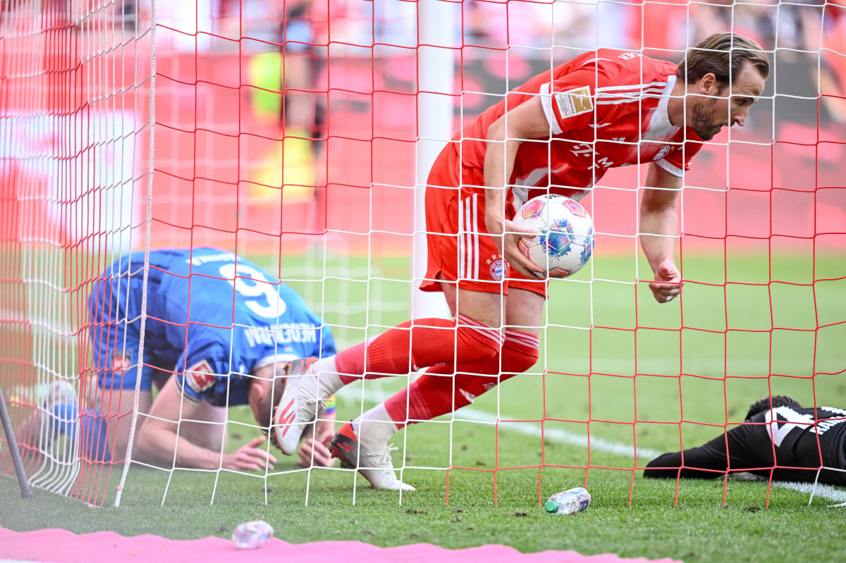Bayern's Harry Kane retrieves the ball from the goal after the 3:3 during a German Bundesliga soccer match between Bayern Munich and 1. FC Heidenheim in Munich, Germany, Saturday, May 2, 2026. (Harry Langer/dpa via AP) THE DEUTSCHE FUSSBALL LIGA DFL DOES NOT ALLOW ITS IMAGES TO BE USED AS SEQUENCES TO EMULATE VIDEO; GERMANY OUT; MANDATORY CREDIT
