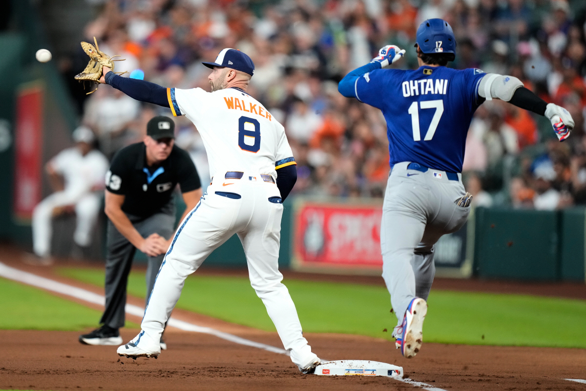 Los Angeles Dodgers designated hitter Shohei Ohtani (17) is out at first after a throw to Houston Astros first baseman Christian Walker (8) during the first inning of a baseball game in Houston, Monday, May 4, 2026. (AP Photo/Ashley Landis)