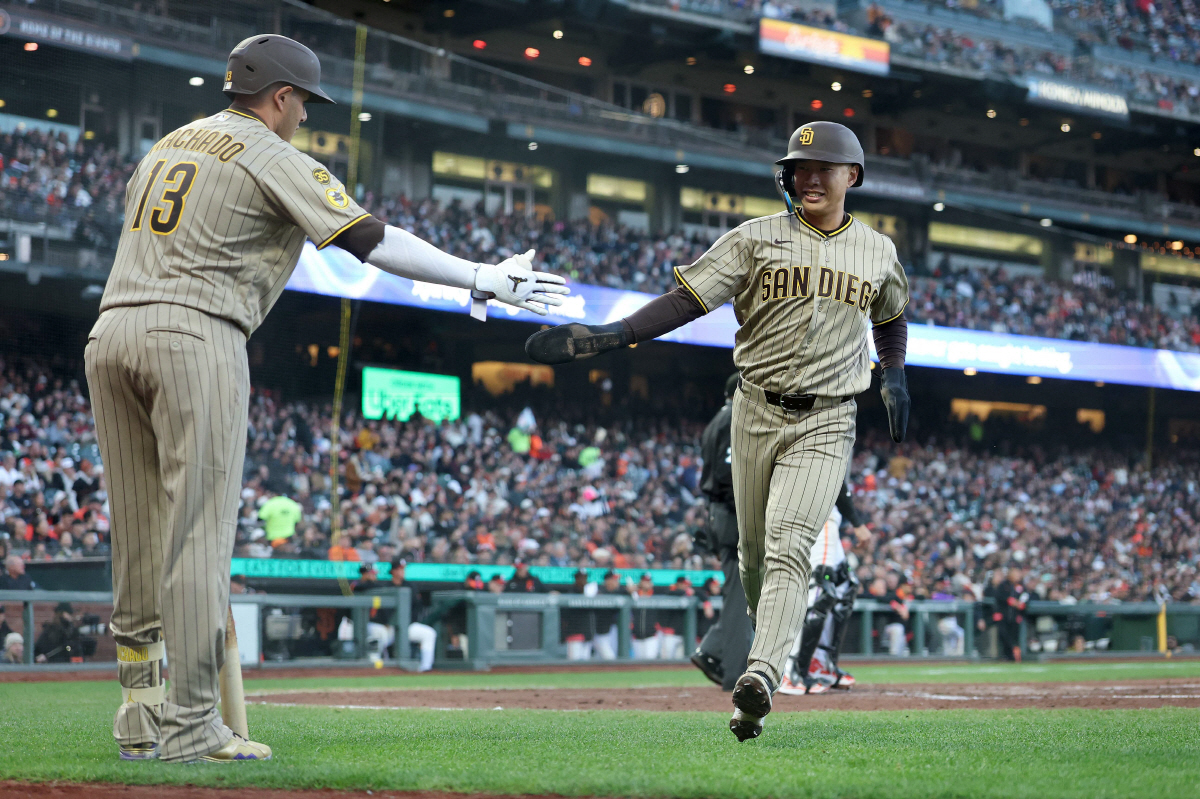 SAN FRANCISCO, CALIFORNIA - MAY 05: Sung-Mun Song #24 of the San Diego Padres is congratulated by Manny Machado #13 against the San Francisco Giants in the fourth inning at Oracle Park on May 05, 2026 in San Francisco, California. It was Song's first Major League hit. Ezra Shaw/Getty Images/AFP (Photo by EZRA SHAW / GETTY IMAGES NORTH AMERICA / Getty Images via AFP)