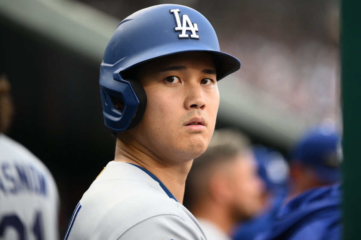 Los Angeles Dodgers' Shohei Ohtani looks on from the dugout before the start of the seventh inning of a baseball game against the Washington Nationals, Saturday, April 4, 2026, in Washington. (AP Photo/Nick Wass)