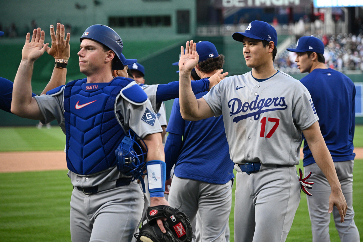 Los Angeles Dodgers' Shohei Ohtani (17) and catcher Will Smith, left, celebrate after a baseball game against the Washington Nationals, Saturday, April 4, 2026, in Washington. (AP Photo/Nick Wass)