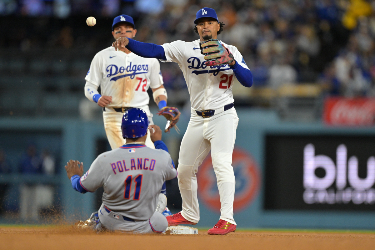 Apr 13, 2026; Los Angeles, California, USA; New York Mets second baseman Jorge Polanco (11) is out as Los Angeles Dodgers second baseman Santiago Espinal (21) throws to first for a double play in the fifth inning at Dodger Stadium. Mandatory Credit: Jayne Kamin-Oncea-Imagn Images